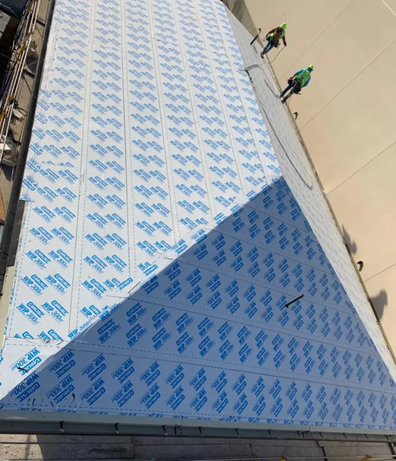 Professional roofers installing underlayment on a metal roof in Sierra Vista